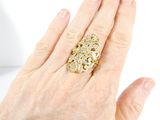 an image of a woman ' s hand holding a gold and diamond ring