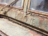 a close up of an old train car with a broken window