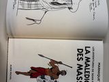 two books that are open on a table