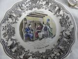 a plate with a picture of people sitting at a table