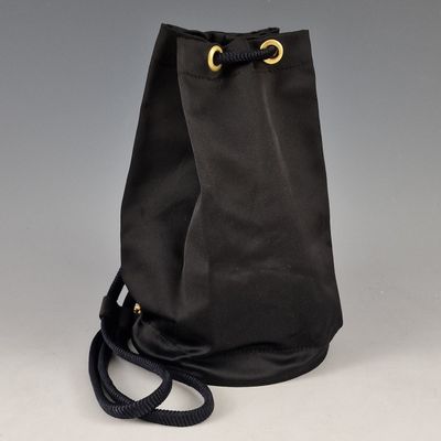 a black bag with a gold ring on the handle