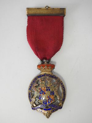 a close up of a medal with a red ribbon around it