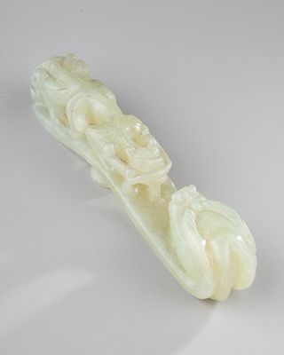 carvings of a boat made of jade on a white surface