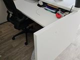 a desk with two monitors and a keyboard on it