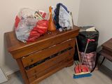 a dresser with a bunch of bags on top of it