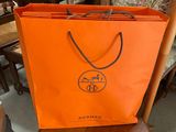 an orange bag sitting on top of a wooden chair