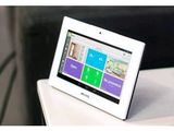 a tablet computer sitting on top of a white table