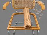 a wicker chair with a wicker seat and a wicker arm rest