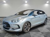 a silver car is parked on a checkered floor in a room