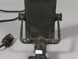 a microphone with a cord attached to it and a charger attached to it