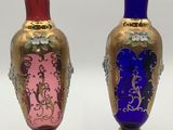 two vases sitting side by side on a white surface