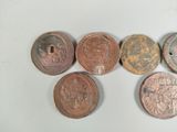 six different types of coins sitting on top of a white surface