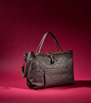 a louis vuitton bag on a red background