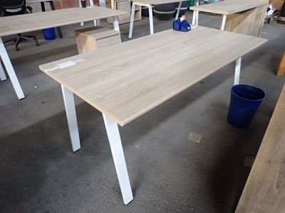 many tables and chairs in a room with a blue bucket