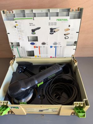 an open box with a corded sander and a corded sander in it