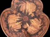 a wooden tray with a flower design on it