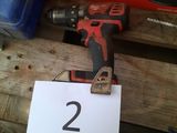 a drill that is sitting on top of a wooden table