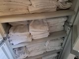 a closet full of folded towels and folded towels