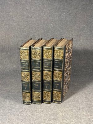three books sitting on top of each other on a table