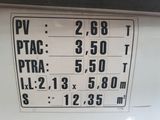 a sign on the side of a white truck that has numbers on it