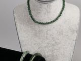 necklace and bracelet on a mannequin stand with a white background