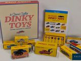 a box of dinky toys sitting next to a box of other dinky toys