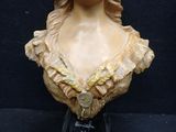 a bust of a woman with a flower in her hair