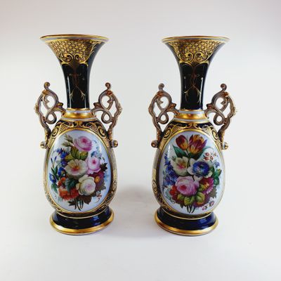 pair of vases decorated with flowers on a white background