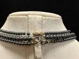 a close up of a necklace on a mannequin mannequin