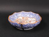 an image of a blue and white bowl on a black surface