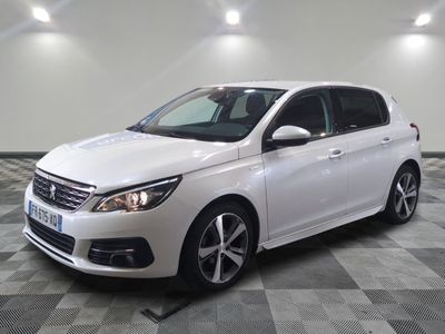the white car is parked on a checkered floor in the garage
