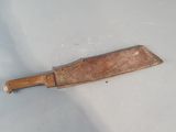 a wooden knife on a white surface with a shadow on it