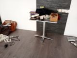 an image of a room with a table and a suitcase