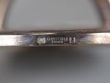an image of a close up of a silver plate with a name on it