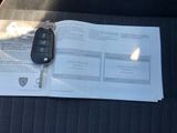a car key sitting on top of a piece of paper in the back seat of a car