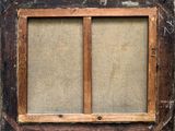 an old wooden window frame with a burlock cloth covering the window