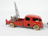 a red toy truck with a crane on the back of it