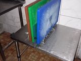 a metal table with a bunch of cutting boards on top of it