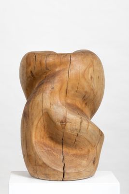 an image of a wooden sculpture on a pedestal on a white surface