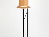 the floor lamp is made of black metal and has a brown shade