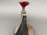 an image of a toy soldier ' s helmet with a red mohawk