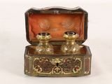 a small box with two candles inside of it