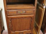 a wooden cabinet with a drawer on top of it