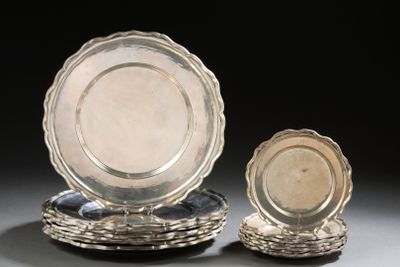 two silver plates and a silver plate on a black background