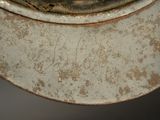 a close up of a metal bowl with a rusted surface