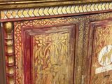 a wooden cabinet with a picture on top of it