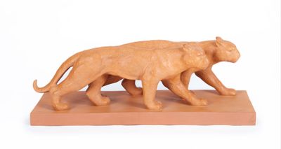 une statue représentant un lion et son lionceau, posée sur un socle