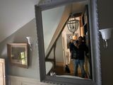 a man taking a picture of himself in the mirror in the bathroom
