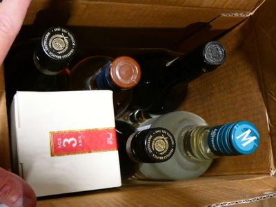 a person holding a bottle of wine in a box
