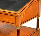a small wooden desk with a black top on it